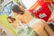 A woman in a white underwear is washing her hands in a sink.