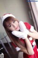 A woman in a santa claus outfit posing for a picture.