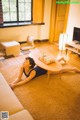 A woman laying on the floor in a living room.