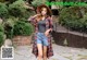 A woman wearing a hat and a plaid shirt is posing for a picture.