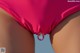 A close up of a woman's butt with a pink bikini bottom.