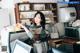 A woman sitting at a counter in a coffee shop.