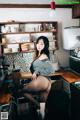 A woman sitting on top of a counter in a kitchen.