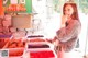 A woman standing in front of a display of dried fruits.